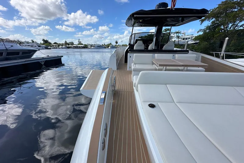 Slide: The Image of 2025 Solaris Power 44 Open yacht with sleek deck design, docked by the water. - 6