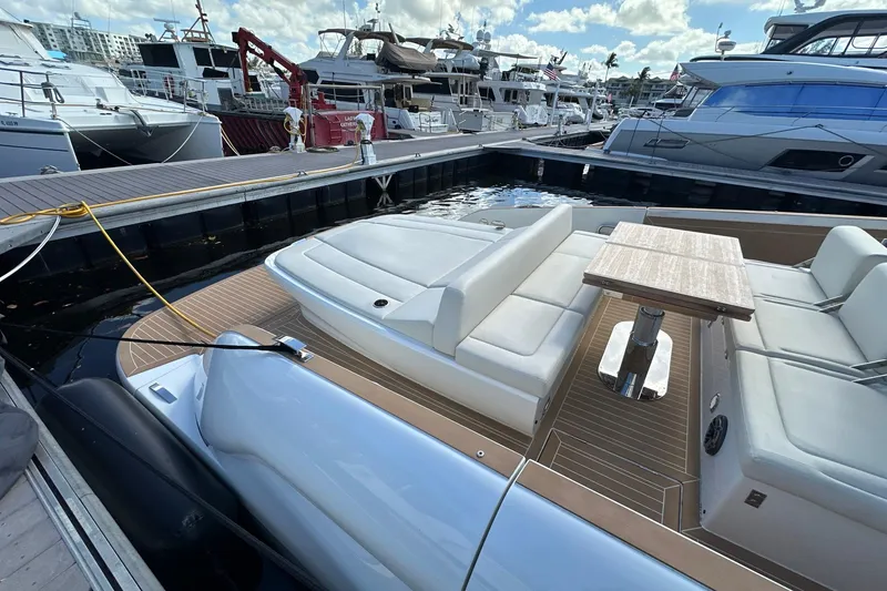 Slide: The Image of 2025 Solaris Power 44 Open yacht docked, featuring sleek seating and a wooden table. - 8