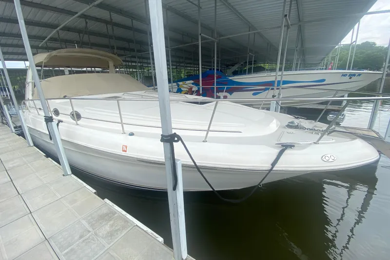 The Image of 2001 Sea Ray 340 Sundancer docked in a covered marina slip. - 1