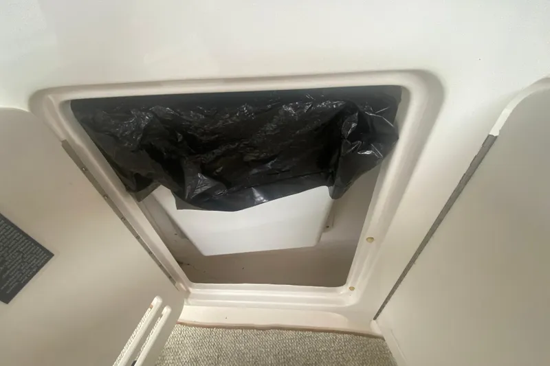 Slide: The Image of Storage compartment on a 2001 Sea Ray 340 Sundancer boat with black cover. - 11