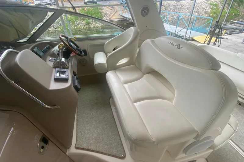 Slide: The Image of Interior of 2001 Sea Ray 340 Sundancer boat with beige seating and helm. - 12