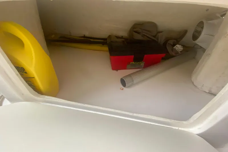 Slide: The Image of Storage compartment of a 2001 Sea Ray 340 Sundancer with tools and supplies. - 14