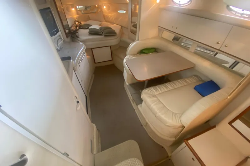 Slide: The Image of Interior of 2001 Sea Ray 340 Sundancer yacht with cozy seating and dining area. - 16