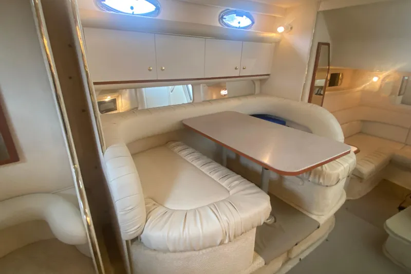 Slide: The Image of Interior of 2001 Sea Ray 340 Sundancer yacht with plush seating and dining table. - 22