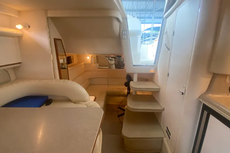 Slide: The Image of Interior of 2001 Sea Ray 340 Sundancer yacht, featuring cozy seating and elegant design. - 23
