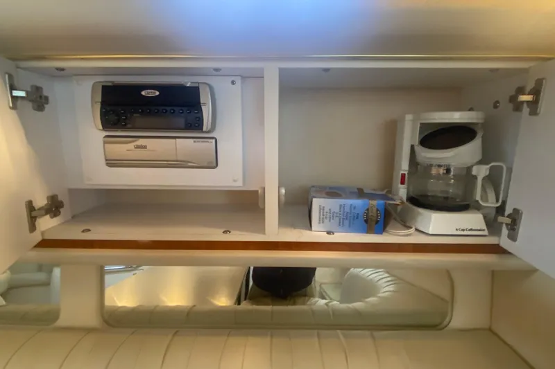 Slide: The Image of 2001 Sea Ray 340 Sundancer cabin with stereo, coffee maker, and storage cabinet. - 24