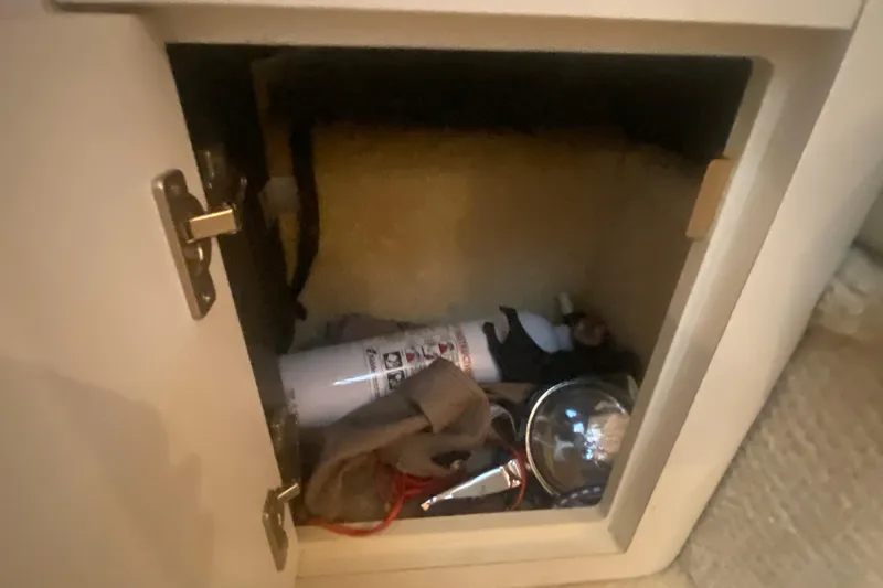 Slide: The Image of Open storage compartment on 2001 Sea Ray 340 Sundancer boat with fire extinguisher. - 28