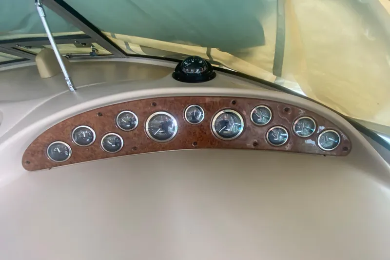 Slide: The Image of Dashboard of a 2001 Sea Ray 340 Sundancer boat with multiple gauges and compass. - 30