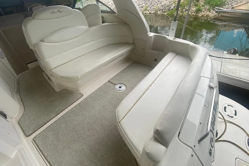 Slide: The Image of 2001 Sea Ray 340 Sundancer boat interior with white seating and carpeted floor. - 4