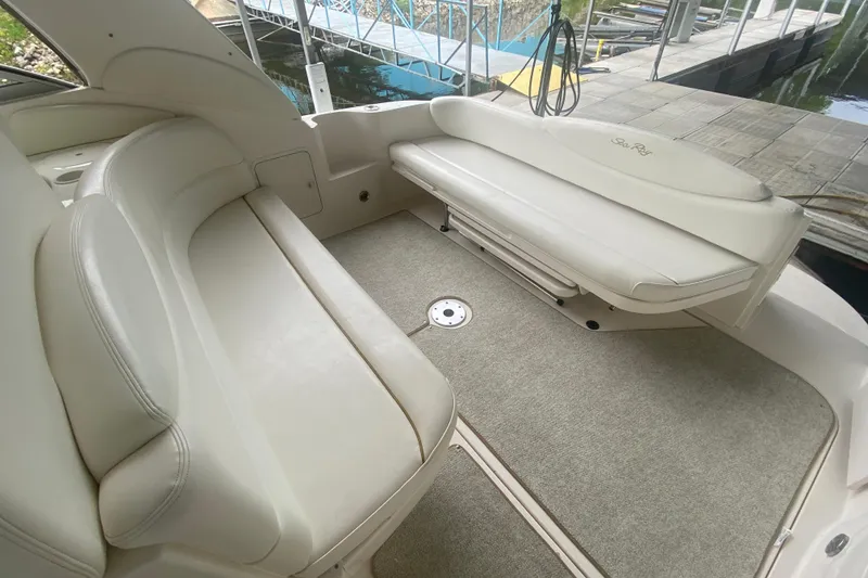 Slide: The Image of 2001 Sea Ray 340 Sundancer boat interior with white leather seating and carpeted floor. - 5