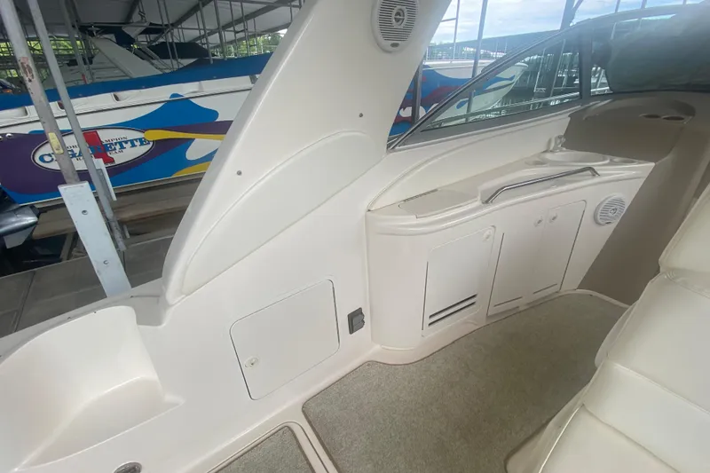Slide: The Image of Interior view of a 2001 Sea Ray 340 Sundancer boat, showcasing seating and storage. - 7