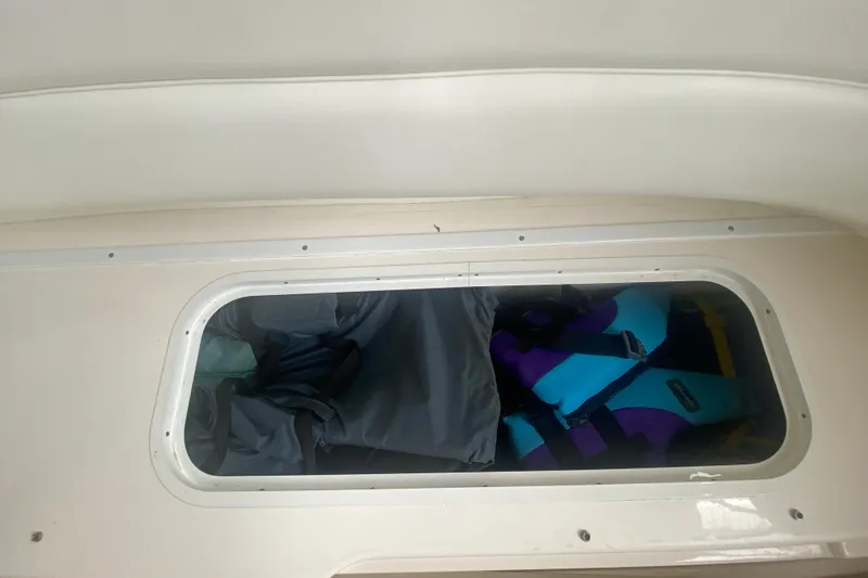 Slide: The Image of Storage compartment on a 2001 Sea Ray 340 Sundancer with life jackets inside. - 8