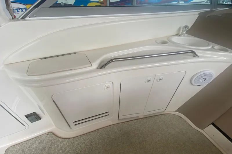 Slide: The Image of 2001 Sea Ray 340 Sundancer interior with sink, storage cabinets, and speaker. - 9