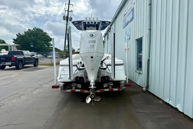 Slide: The Image of 2025 BlackJack 256 Coastal boat with Yamaha 300 V6 engine on a dock lift. - 14