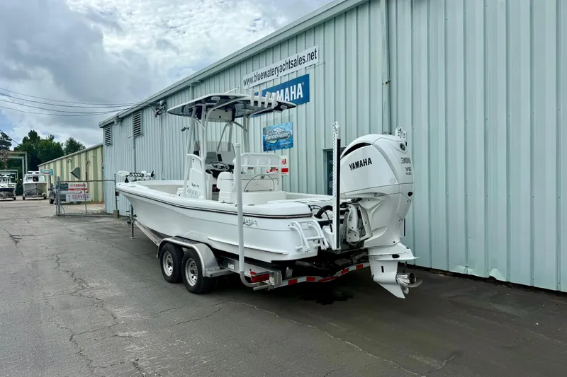 Slide: The Image of 2025 BlackJack 256 Coastal boat docked, featuring Yamaha engine and white seating. - 15