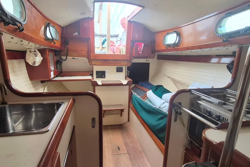 Slide: The Image of Interior of a 1996 Morris Yachts Frances sailboat, featuring a cozy cabin layout. - 11