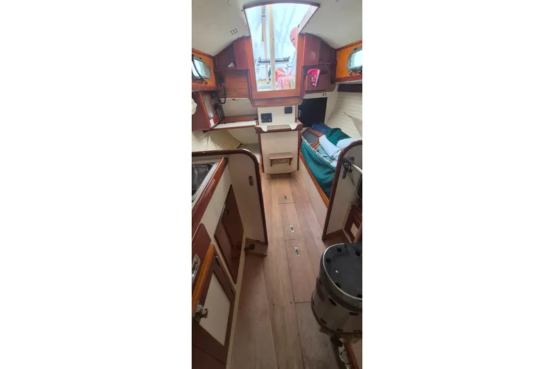 Slide: The Image of Interior of a 1996 Morris Yachts Frances sailboat, featuring cozy wooden furnishings. - 12
