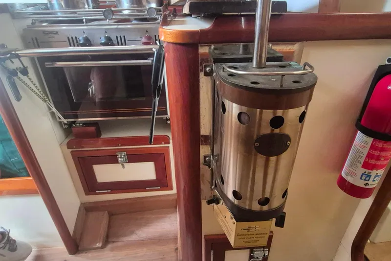 Slide: The Image of Interior of 1996 Morris Yachts Frances, featuring a stove and fire extinguisher. - 15