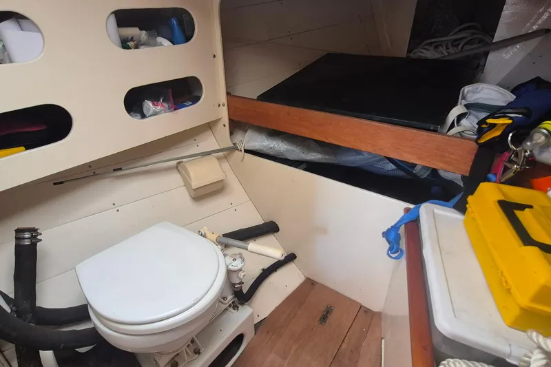 Slide: The Image of Interior of 1996 Morris Yachts Frances, featuring compact marine toilet and storage compartments. - 17