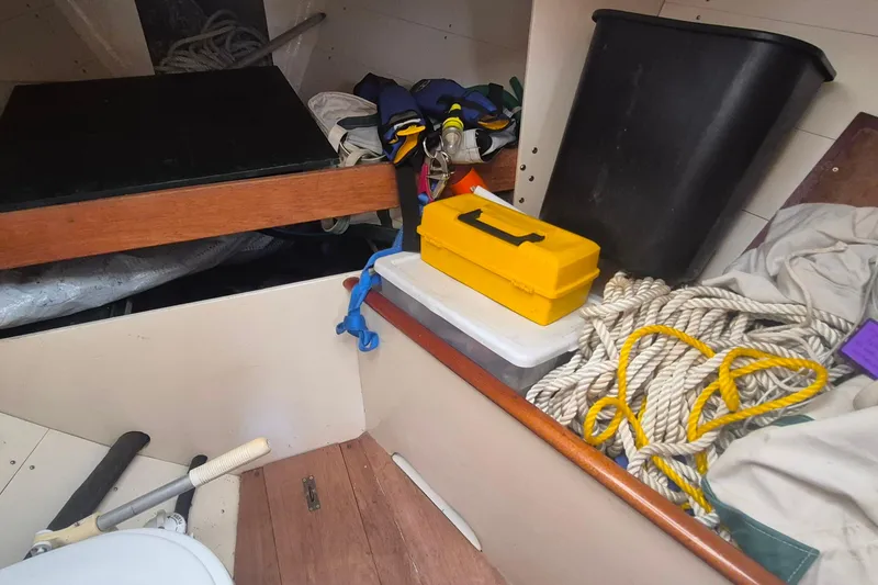 Slide: The Image of Interior of 1996 Morris Yachts Frances with ropes, toolbox, and storage items. - 18
