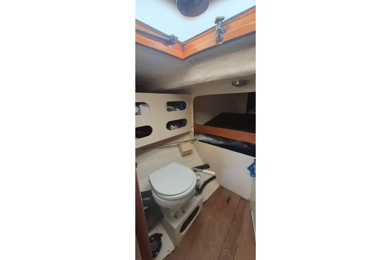 Slide: The Image of 1996 Morris Yachts Frances interior with compact toilet and storage shelves. - 19