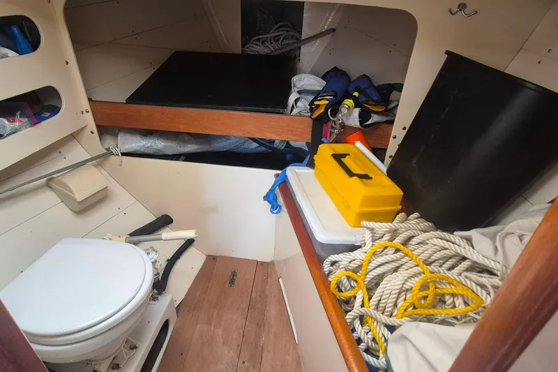 Slide: The Image of Interior of 1996 Morris Yachts Frances, featuring storage, ropes, and marine toilet. - 20