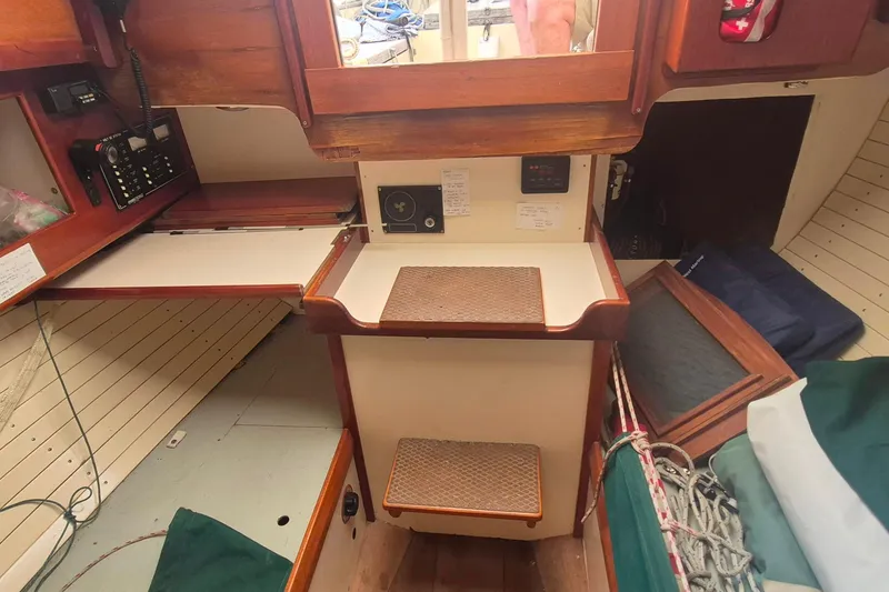 Slide: The Image of Interior of a 1996 Morris Yachts Frances, featuring wooden cabinetry and navigation equipment. - 21