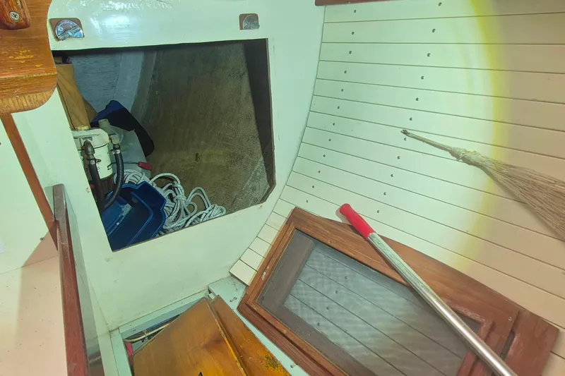 Slide: The Image of Interior of 1996 Morris Yachts Frances, showing storage area with ropes and cleaning tools. - 28