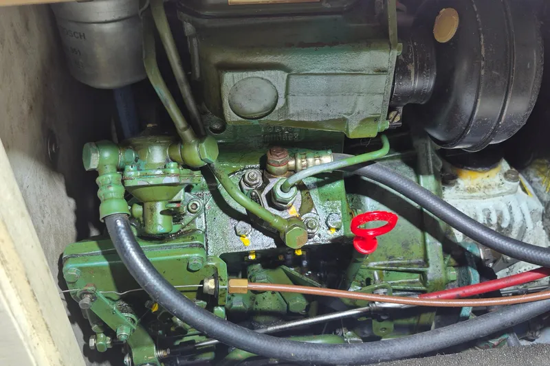 Slide: The Image of Engine compartment of a 1996 Morris Yachts Frances, showcasing mechanical components and hoses. - 31