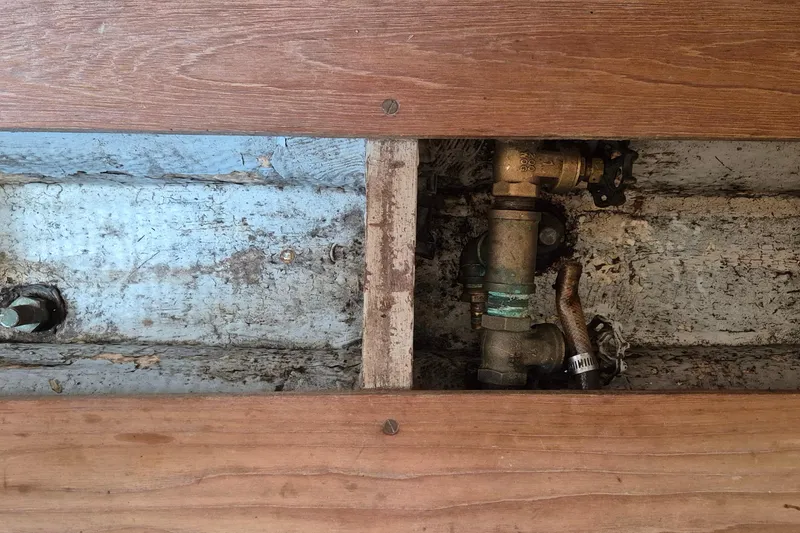 Slide: The Image of Bilge area of 1996 Morris Yachts Frances, showing plumbing and wooden flooring. - 35