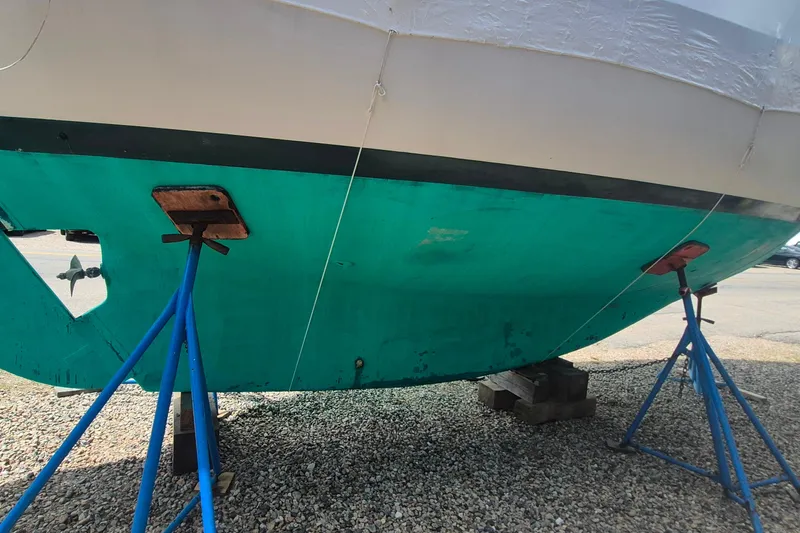 Slide: The Image of 1996 Morris Yachts Frances sailboat hull on stands, showing turquoise bottom paint. - 45