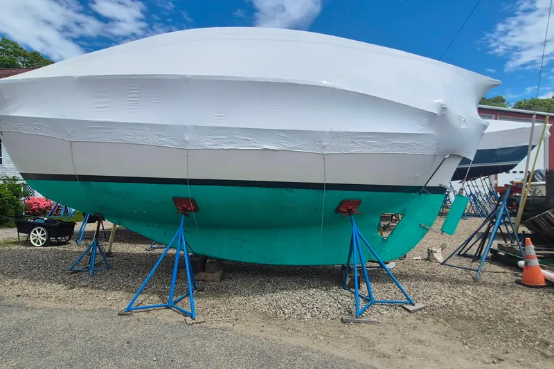 Slide: The Image of 1996 Morris Yachts Frances sailboat on stands, wrapped for storage, under a clear blue sky. - 46