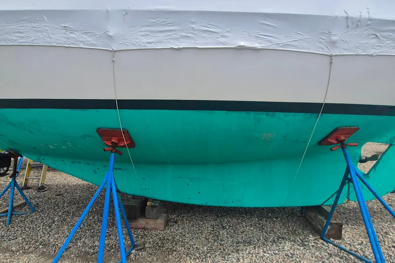 Slide: The Image of 1996 Morris Yachts Frances sailboat hull on stands, turquoise and white paint visible. - 47