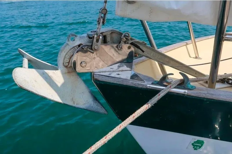 Slide: The Image of Anchor on Morris Yachts Frances 1996, secured with rope, floating on blue water. - 52