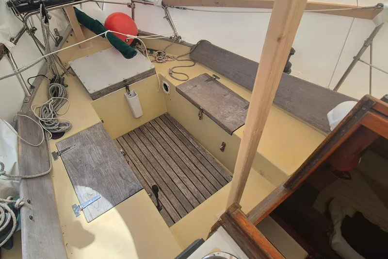 Slide: The Image of 1996 Morris Yachts Frances sailboat cockpit with wooden seating and nautical ropes. - 7