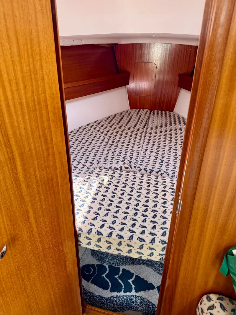 Slide: The Image of Interior of 2000 Dufour 32 Classic yacht with cozy sleeping area. - 15