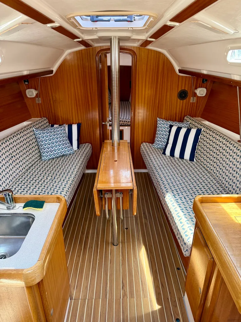 Slide: The Image of Interior of a 2000 Dufour 32 Classic yacht with wooden finish. - 9