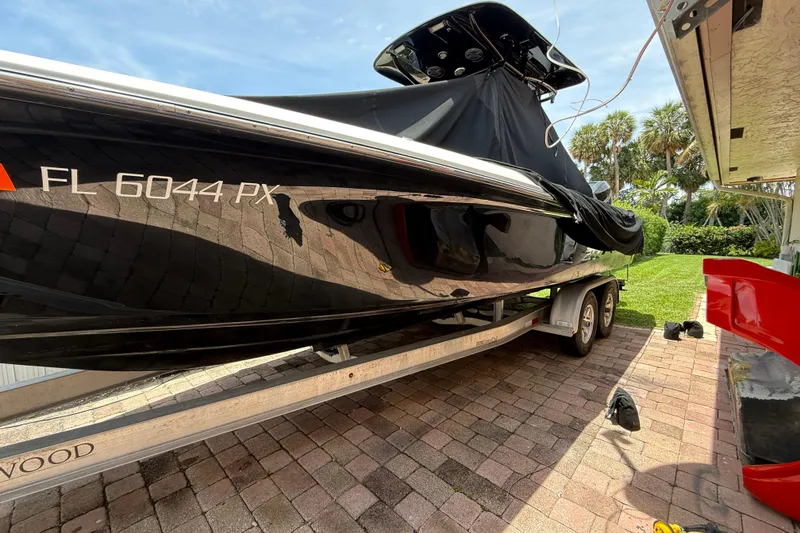 The Image of 2015 Blackwood 27 boat on trailer, covered, parked on brick driveway. - 0