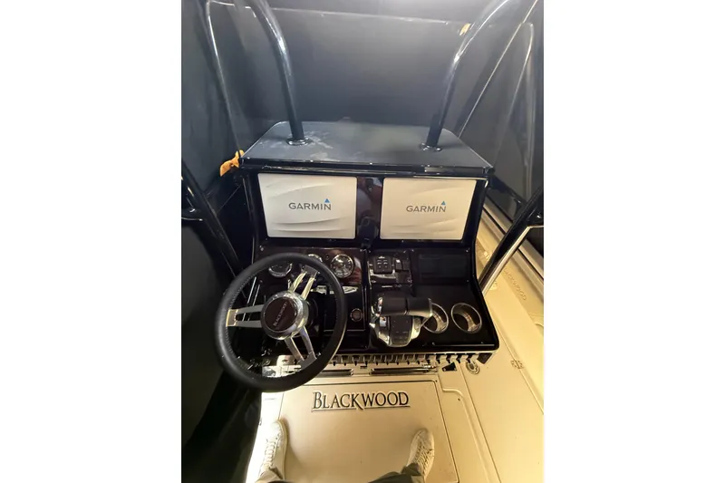 Slide: The Image of Cockpit of 2015 Blackwood 27 boat with Garmin navigation system and steering wheel. - 11