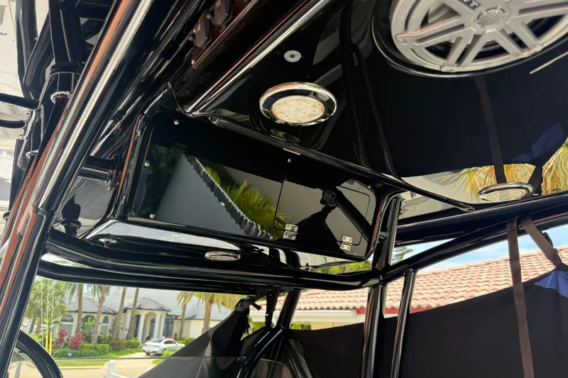 Slide: The Image of Interior view of a 2015 Blackwood 27 boat with sleek black finish and speaker system. - 13