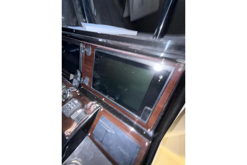 Slide: The Image of Dashboard of a 2015 Blackwood 27 boat with electronic controls and display. - 14
