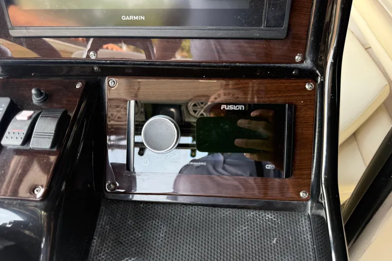 Slide: The Image of Control panel of a 2015 Blackwood 27 boat featuring Garmin and Fusion systems. - 15