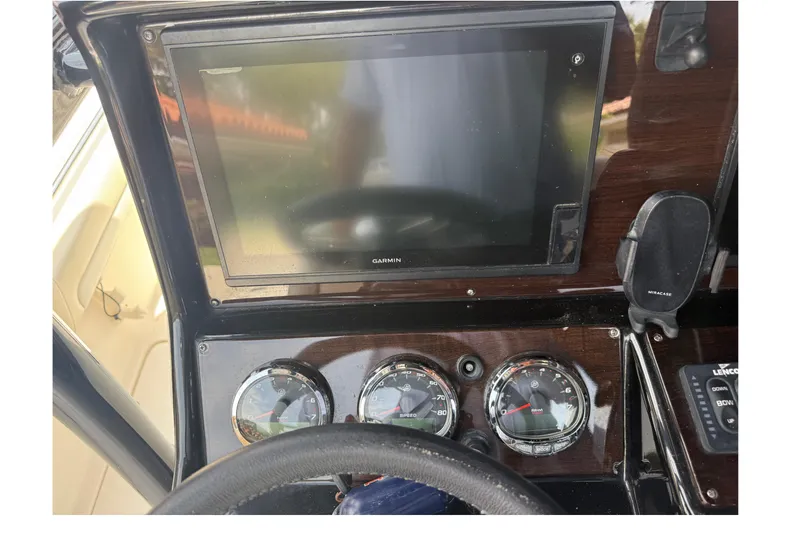 Slide: The Image of Dashboard of a 2015 Blackwood 27 boat with Garmin display and gauges. - 16