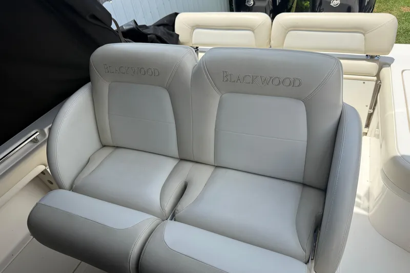 Slide: The Image of Luxury seating on a 2015 Blackwood 27 boat, featuring embroidered branding. - 18