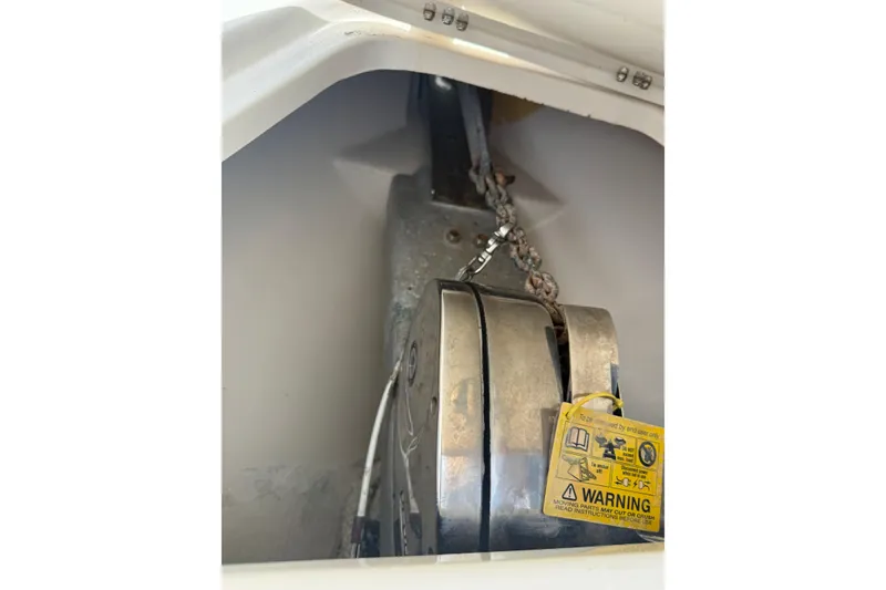 Slide: The Image of Anchor chain mechanism in a 2015 Blackwood 27 boat, featuring a warning label. - 24
