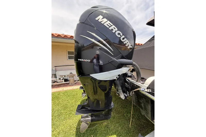 Slide: The Image of 2015 Blackwood 27 boat with Mercury Verado outboard motor in a yard setting. - 31