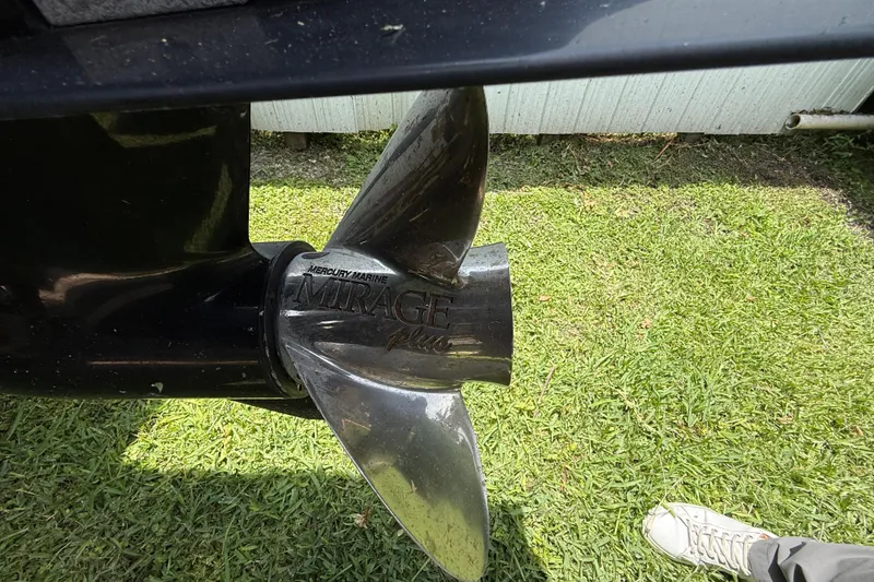 Slide: The Image of Mercury Marine Mirage Plus propeller on Blackwood 27 boat, 2015 model, on grass. - 32