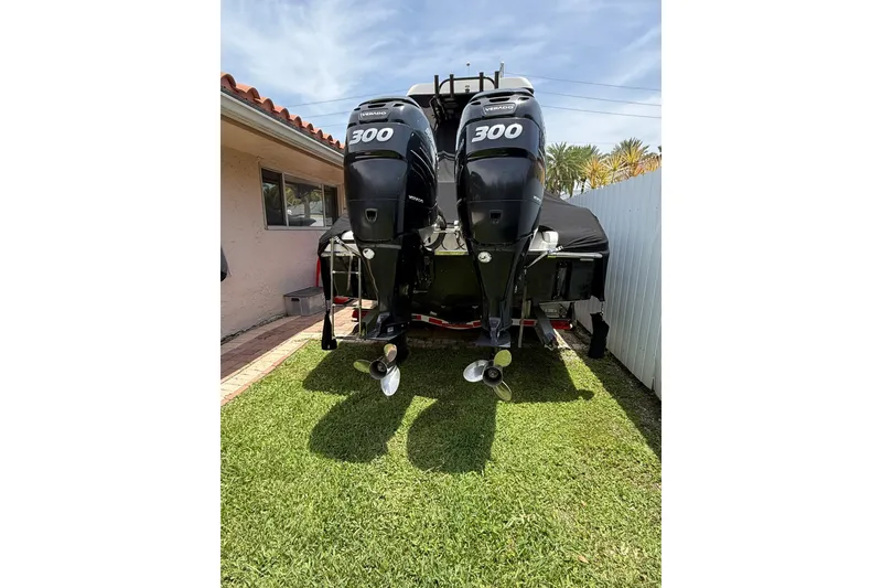 Slide: The Image of 2015 Blackwood 27 boat with twin 300 horsepower engines, parked on grass. - 33