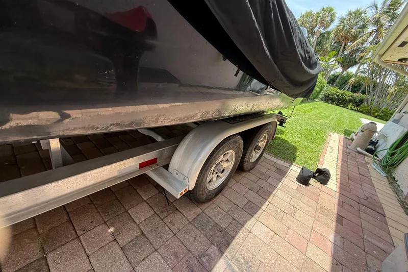 Slide: The Image of Trailer with a covered 2015 Blackwood 27 boat parked on a brick driveway. - 4