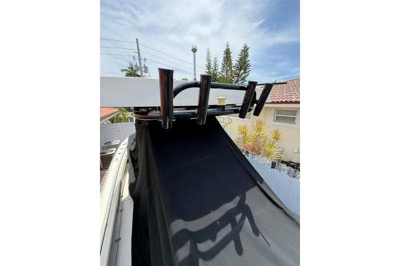 Slide: The Image of Boat with black cover and rod holders, Blackwood 27, 2015 model, sunny day. - 5